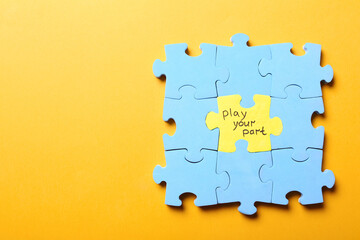 Jigsaw puzzle with phrase Play Your Part on yellow background, top view. Social responsibility concept