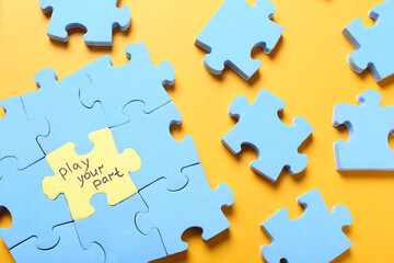 Jigsaw puzzle with phrase Play Your Part on yellow background, flat lay. Social responsibility...