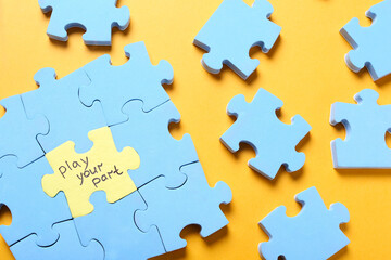 Jigsaw puzzle with phrase Play Your Part on yellow background, flat lay. Social responsibility concept - obrazy, fototapety, plakaty