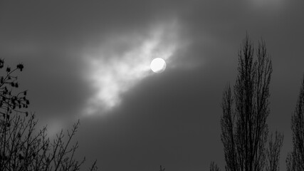 The Sun behind clouds in the sky