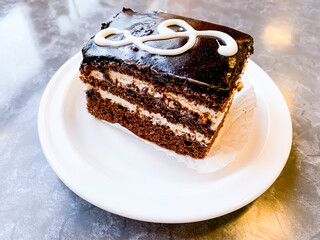 Piece of delicious cake decorated with treble clef. Studio Photo
