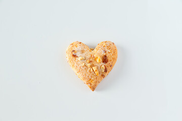 One heart shaped cookie on a white background