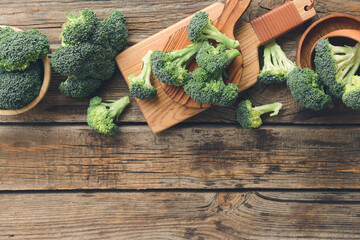 Board with fresh broccoli cabbage on wooden background