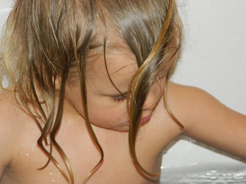 Close-up Of Shirtless Girl Taking Bath At Home