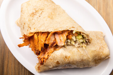 Pastor mexican burrito on wooden background. Traditional mexican food on wooden table. Shawarma concept. Mexican food concept with text space