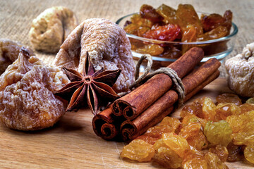 figs, cinnamon, anise and raisins on wooden tray, selective focus