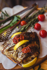 Fish Meat on a Black Tray with Herbs and Spices on Top of a Rustic Wooden Table