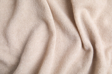Warm cashmere sweater as background, top view