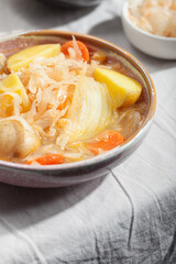 Vegetarian sauerkraut soup shchi with veggies close-up. Comfort healthy food