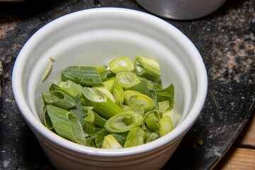 Cut spring onion in a bowl ready to be used as cooking ingredients