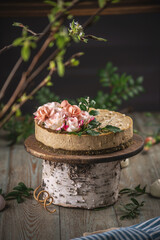 Delicious and beautiful raw cake decorated with tenderness fresh flowers. Concept of romantic mood and spring atmosphere