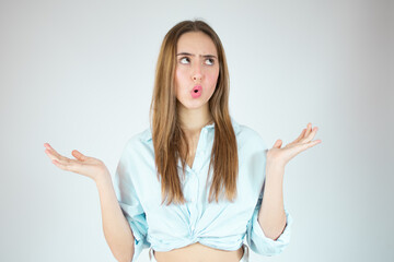 Young woman over isolated white background thinking an idea while looking up