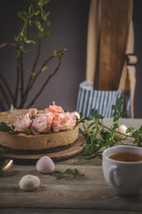 Delicious and beautiful raw cake decorated with tenderness fresh flowers. Concept of romantic mood and spring atmosphere