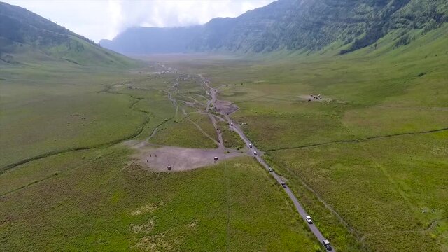 Malang East Java, Indonesia. The view of the jeep crossing Savana Bromo and Teletubbies Hill on Mount Bromo using a drone.