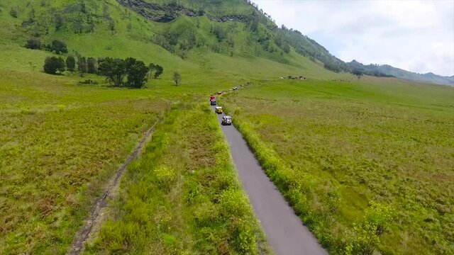 Malang East Java, Indonesia. The view of the jeep crossing Savana Bromo and Teletubbies Hill on Mount Bromo using a drone.