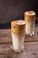 Dalgona Coffee. Whipped icing drink with instant coffee popular in Korea Creamy cocktail in tall Glasses.