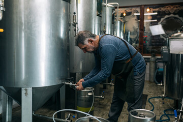 brewer working in his craft beer brewery