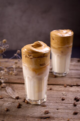 Dalgona Coffee. Whipped icing drink with instant coffee popular in Korea Creamy cocktail in tall Glasses.