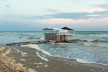 End of vacation season at Koblevo seaside at evening in Ukraine. The text of the signboard is...