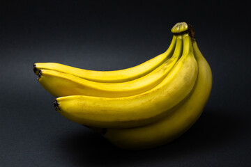 Bananas on a black background. Healthy food. Banana bunch