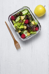 Healthy vegan take away salad in aluminum container