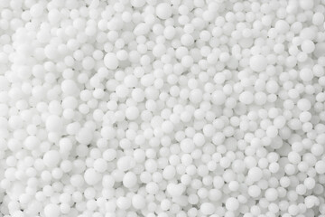 Pellets of ammonium nitrate as background, top view. Mineral fertilizer