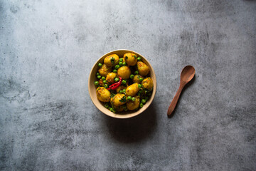 Popular Indian food item aloo dum or potatoes cooked in slow fire in a bowl. Top view, selective focus.