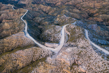 A winding road suns through the desert