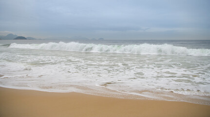 Fototapeta na wymiar Ocean surf on the beach of Copacabana. Rio de Janeiro, February 2020