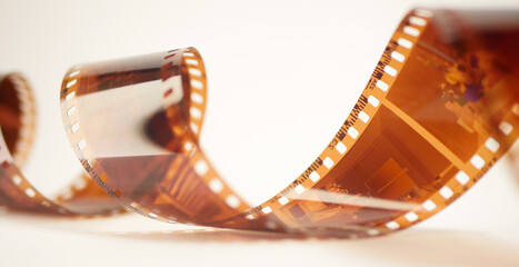 Close up 35mm film strip. White background. Analog photography banner. Spiral photo strip 