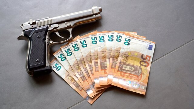revolver gun army  and money cash banknote  50 euro - mafia and criminal life