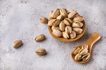 Organic pistachio nuts in bowl on table.