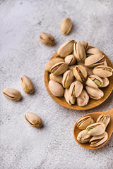 Organic pistachio nuts in bowl on table.