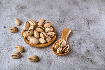 Organic pistachio nuts in bowl on table.