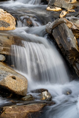 a mountain creek in the spring with water of melting snow, long exposure water photography