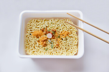 Chinese spiced noodles with wooden chopsticks. The concept of fast food, dry noodles