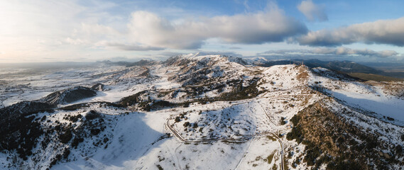 Aerial panoramic view over snow covered high mountains. High quality photo.