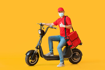 Fototapeta na wymiar Courier of food delivery service showing thumb-up on color background