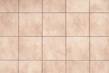 Beige ceramic tile background on the floor, bathroom design element, abstract square pattern, brown geometric texture, vintage wall surface.