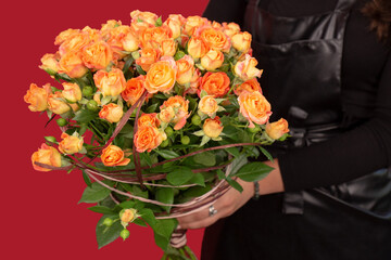 The girl with big bouquet of orange tea roses