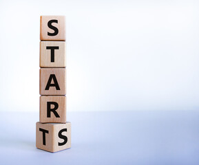 Start to stars symbol. Turned a wooden cube and changed the word 'start' to 'stars'. Beautiful white background, copy space. Business and start to stars concept.