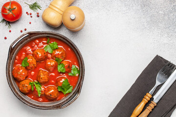 Meat or vegetable meatballs in tomato sauce with beans. Top view.