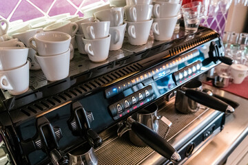 Cups stacked in espresso machine in a restaurant