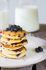 Blueberry pancakes on rustic background