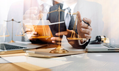 Justice and law concept.Male judge in a courtroom with the gavel, working with, computer and docking keyboard, eyeglasses, on table in morning light