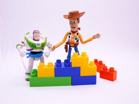 Toy story movie. Woody and Buzz Lightyear. Pixar and Disney movie toys. Cowboy and astronaut.  Isolated white. Toys playing with blocks.