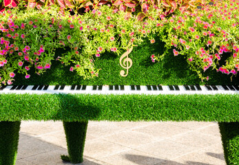 A piano made of flowers and green grass