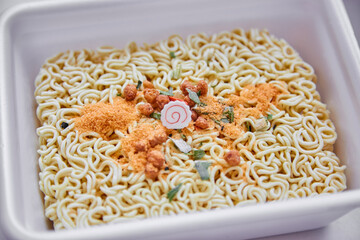 Chinese spiced noodles with wooden chopsticks. The concept of fast food, dry noodles