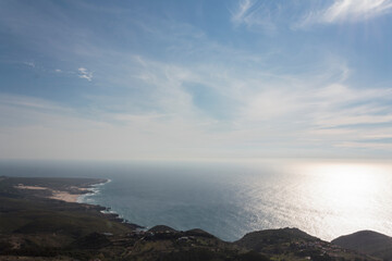 High angle view of coastline, with beach, ocean, blue sky and horizon