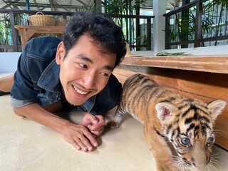 Man and baby tiger